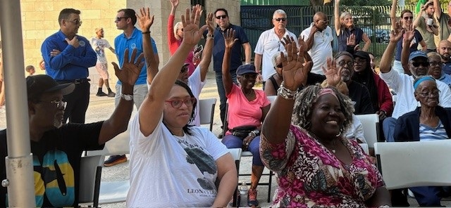 May 29th, 2024 Virrick Park Pool Community Meeting. Photo of attendees watching the presentation being given by the designer.
