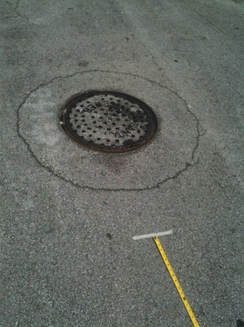 Manhole in need of repair in La Pastorita Neighborhood