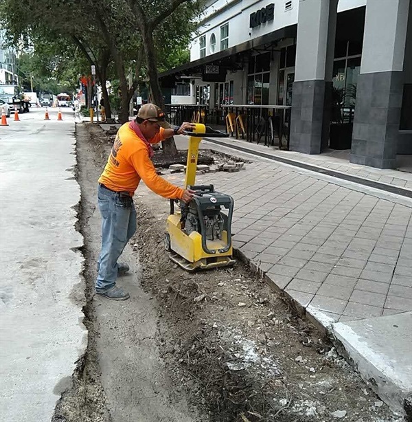 Construction workers working on the road and drainage at Mary Brickell Village